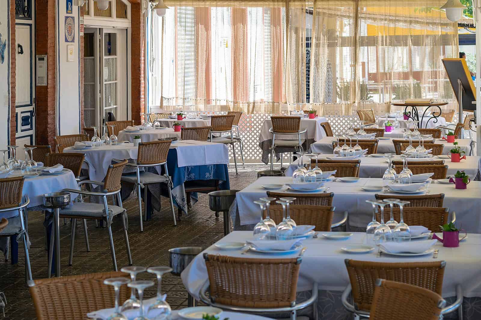 Busy restaurant dining room with staff serving customers